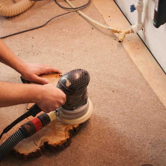 woodworking-specialist-uses-angle-grinder-on-wood-2026-01-08-02-36-39-utc_11zon